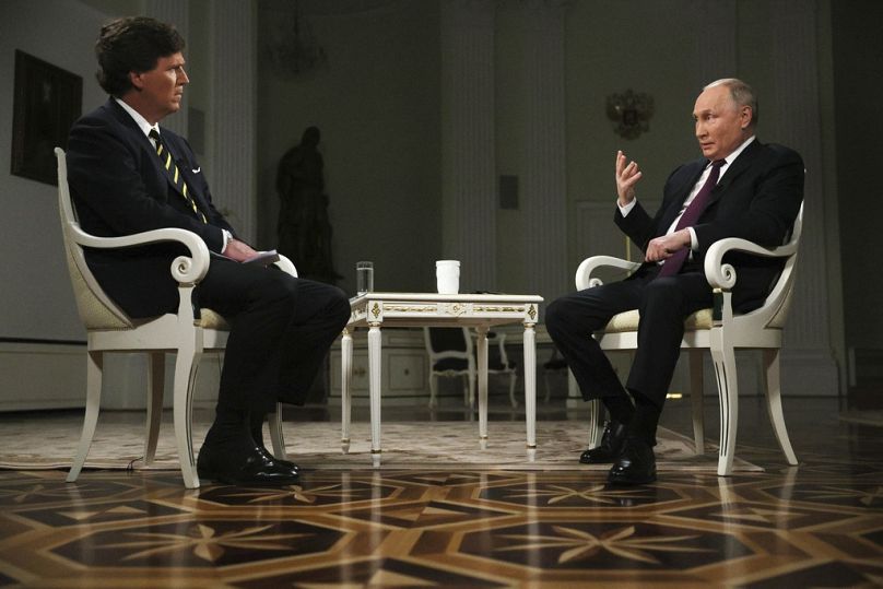 Friday, Feb. 9, 2024, Russian President Vladimir Putin, right, gestures as he speaks during an interview with former Fox News host Tucker Carlson.