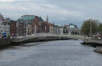 The River Liffey flows past the Ha'penny Bridge in Dublin, Ireland