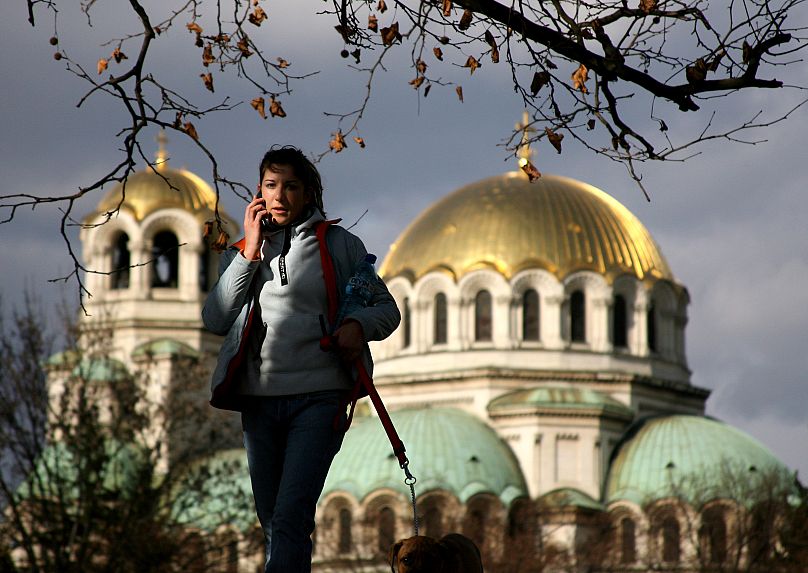 File photo of a Bulgarian girl walking past the golden domed Alexander Nevski cathedral