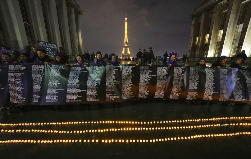 Members of the women #NousToutes group hold a banner with the names of the 900 women killed by their partners at Trocadero Plaza near Eiffel Tower Thursday, Feb 8, 2024.