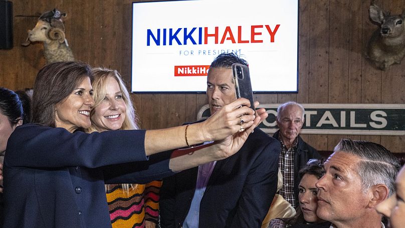 Republican presidential candidate Nikki Haley takes a selfie with a supporter during a campaign stop in California, February 7