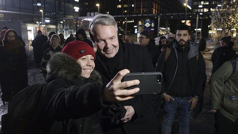 Pekka Haavisto poses for a selfie during a campaign rally in Helsinki