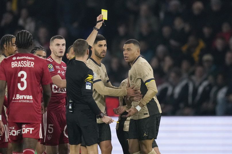Cement Turpin shows a yellow card to PSG's Kylian Mbappe, during the French League One match between Paris Saint-Germain and Brest, Jan 28, 2024.