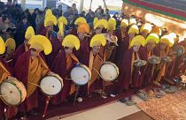 Exiled Tibetan monks leading Tibetan New Year ceremony playing drums, cymbals