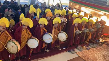 Exiled Tibetan monks leading Tibetan New Year ceremony playing drums, cymbals