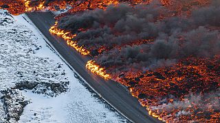 A view of lava crossing the main road to Grindavík and flowing on the road leading to the Blue Lagoon, in Grindavík, Iceland, Thursday, 8 Feb. 2024.