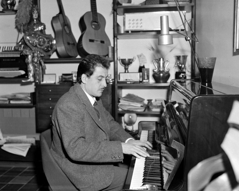Italian composer and singer, Domenico Modugno, plays the piano at his home in Rome, Italy, Nov. 7, 1958.