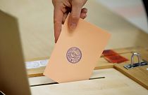 A woman casts her ballot at a polling station during a presidential election in Espoo, Finland, Sunday, Feb. 11, 2024.
