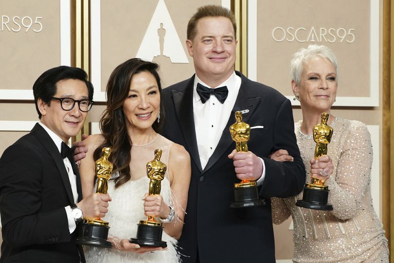 Ke Huy Quan, Michelle Yeoh, Brendan Fraser, and Jamie Lee Curtis pose with their awards at the Oscars on March 12, 2023, in Los Angeles.
