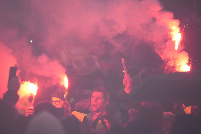 Polish farmers, angry at EU agrarian policy light flares in protest before the office of the regional governor, in Poznan, February 2024