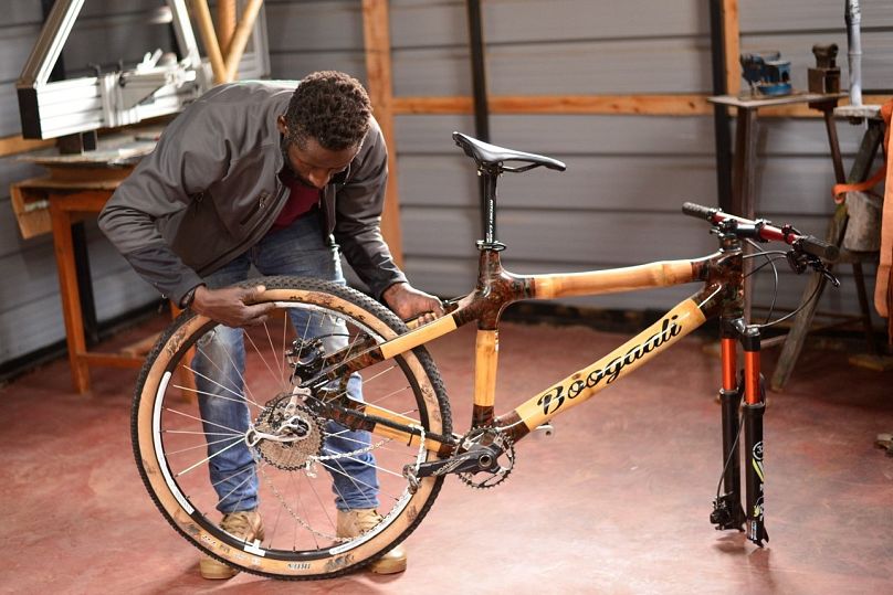 Kasoma wraps the bicycle frame joints in traditional Ugandan barkcloth to strengthen them