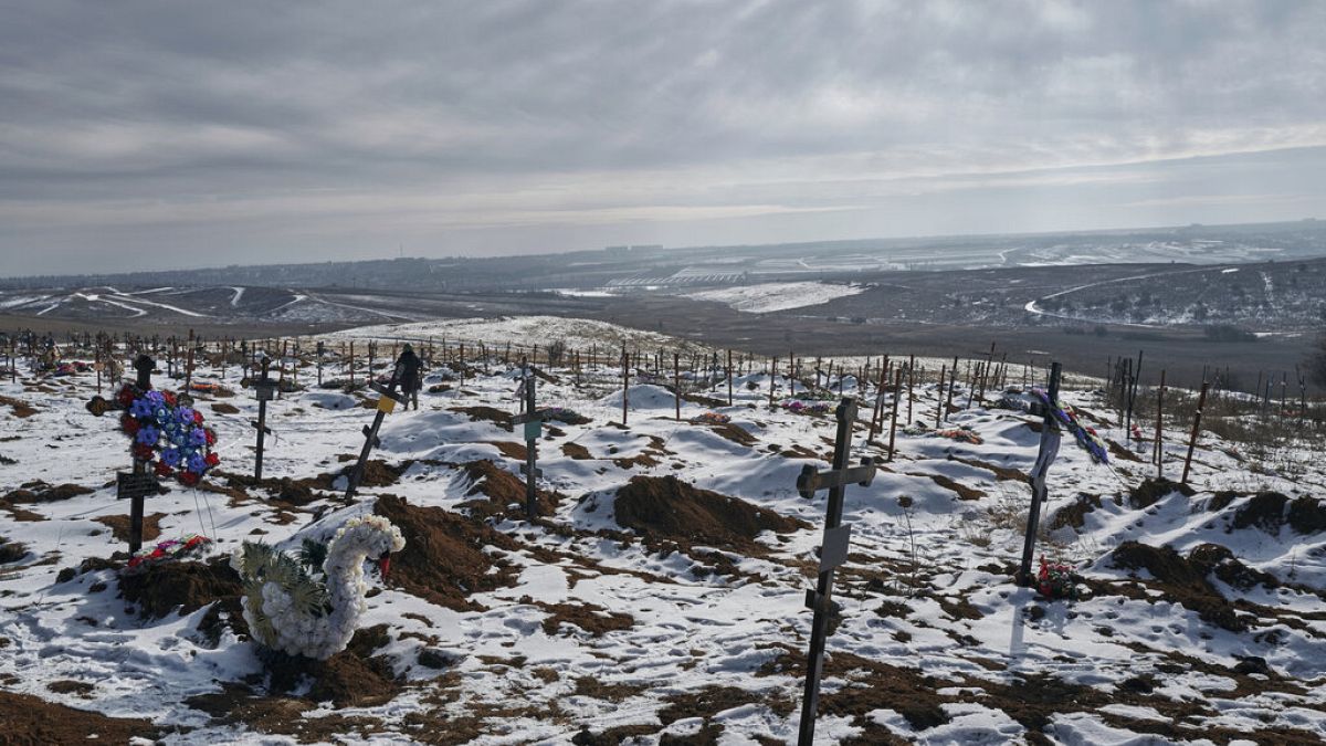 New graves and crosses are scattered in a city cemetery in Bakhmut, Donetsk region, Ukraine, Friday, Feb. 10, 2023. 