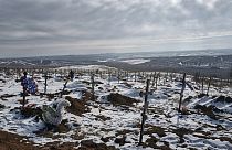 New graves and crosses are scattered in a city cemetery in Bakhmut, Donetsk region, Ukraine, Friday, Feb. 10, 2023. 