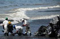 Workers from state own Heritage Petroleum Oil and Gas Company clean up an oil spill that reached Rockly Bay beach, in Scarborough, south western Tobago, Trinidad and Tobago.