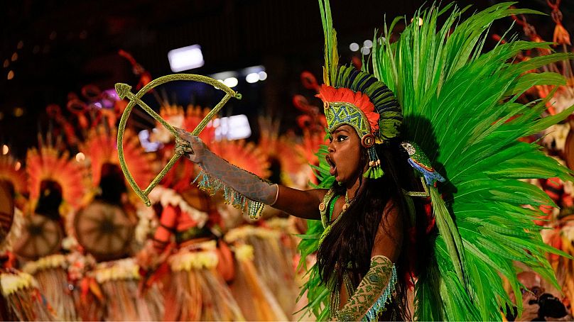 A performer from the Salgueiro samba school parades during Carnival celebrations at the Sambadrome in Rio de Janeiro, Brazil, 12 February 2024.