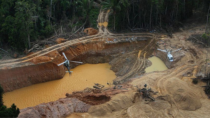 A Brazil Environmental Agency helicopter flies over an illegal mining camp in Yanomami Indigenous territory, Roraima state, Brazil, 11 February 2023.