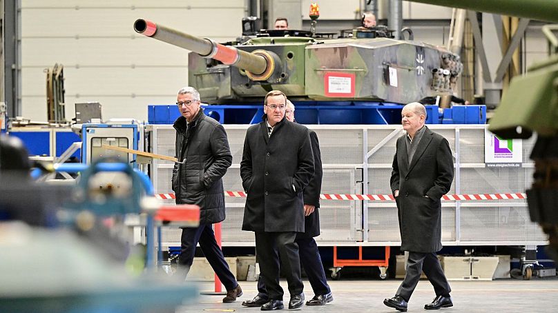 German Chancellor Olaf Scholz, right, and Boris Pistorius, Federal Minister of Defense, inspect a production hall with armoured vehicles from the Rheinmetall armaments group.