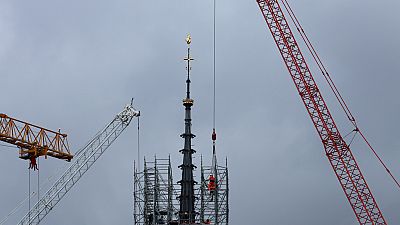 Scaffolding is being removed around the spire of Notre Dame de Paris cathedral, showing the rooster and the cross, Monday, Feb. 12, 2024 in Paris