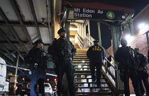 New York City Police officers stand guard following a shooting at the Mount Eden subway station, Monday, Feb. 12, 2024, in the Bronx borough of New York.