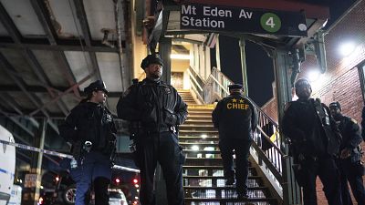 New York City Police officers stand guard following a shooting at the Mount Eden subway station, Monday, Feb. 12, 2024, in the Bronx borough of New York.