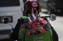 An Uber worker carries a bouquet of flowers to be delivered (file photo)