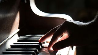 A musician plays the piano