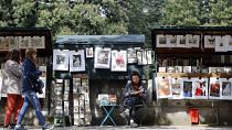 French President Emmanuel Macron has abandoned plans to move the famed second-hand bookseller boxes flanking the banks of the Seine that are beloved by tourists.