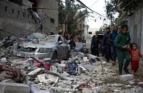 Palestinians look at the destruction after an Israeli airstrike in Rafah, Gaza Strip, Friday, Feb. 9, 2024. 