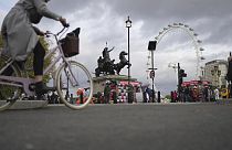 A woman rides a bike in London, Thursday, Nov. 17, 2022. 