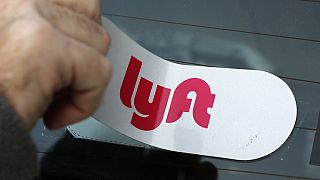 In this Jan. 31, 2018, file photo, a Lyft logo is installed on a Lyft driver's car in Pittsburgh.