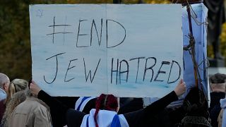 A protester holds up a placard saying 'End Jew Hatred' at a demonstration in London.