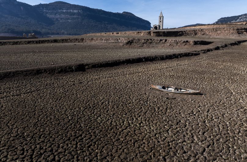 An abandoned kayak lies on the cracked ground at the Sau reservoir north of Barcelona.