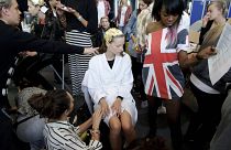 Models wear outfits by designer Bora Asku during his Spring/Summer 2015 show at London Fashion Week in London.