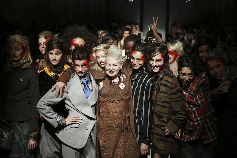 British designer Vivienne Westwood poses with models after her Autumn/Winter 2015 show at London Fashion Week in London.