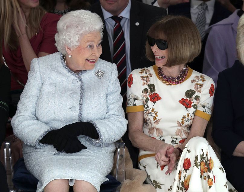 2018 picture of Britain's Queen Elizabeth, sitting next to fashion editor Anna Wintour as they view Richard Quinn's runway show.