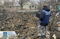 In this photo provided by the Donetsk Regional Prosecutor's Office, a war crime prosecutor inspects the scene after shelling in Pokrovsk, Ukraine, Thursday, Nov. 30, 2023.