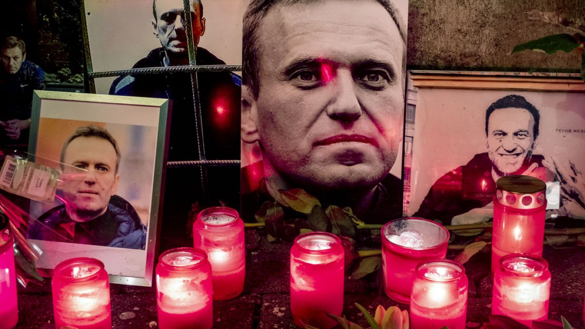 Candles and photos of Russian opposition leader Alexei Navalny are placed near the Russian consulate in Frankfurt, Germany, Saturday, Feb. 17, 2024. 