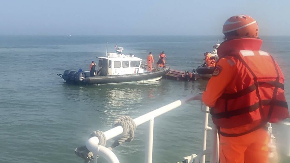 Taiwanese coast guards inspect a vessel that capsized during a chase off the coast of Kinmen archipelago in Taiwan, Feb. 14, 2024.