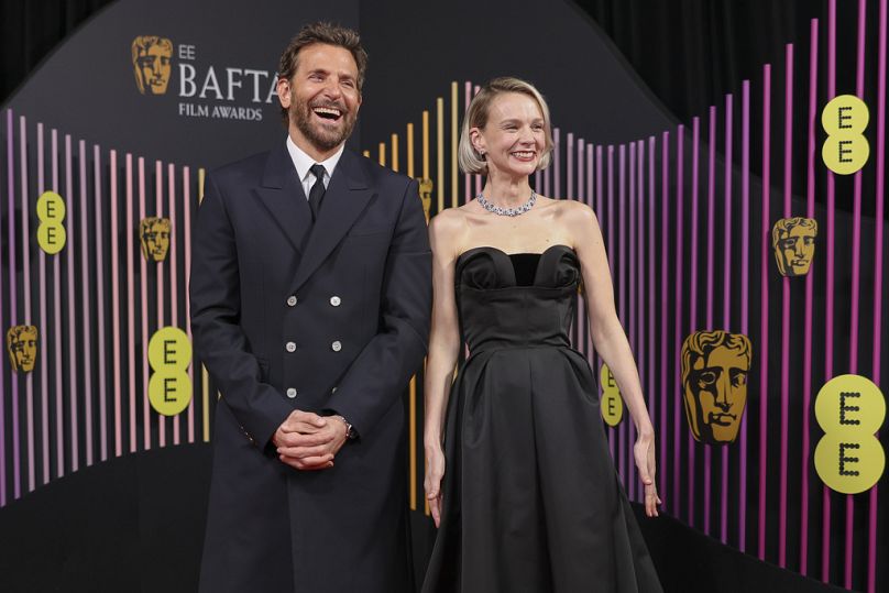 Bradley Cooper, left, and Carey Mulligan pose for photographers upon arrival at the 77th British Academy Film Awards, BAFTA's, in London.