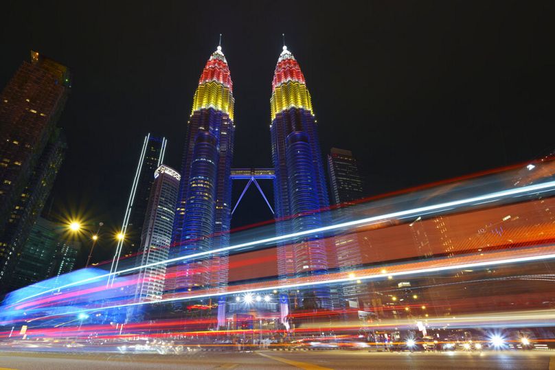 Petronas Twin towers decorated with colour lights during the 64th National Day celebrations to commemorate independence of Malaysia, in Kuala Lumpur, August 2021