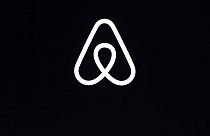 This Feb. 22, 2018, file photo shows an Airbnb logo during an event in San Francisco. 