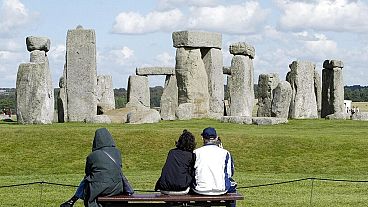 Tourists looking at The Stonehenge on Salisbury Plain in England. 