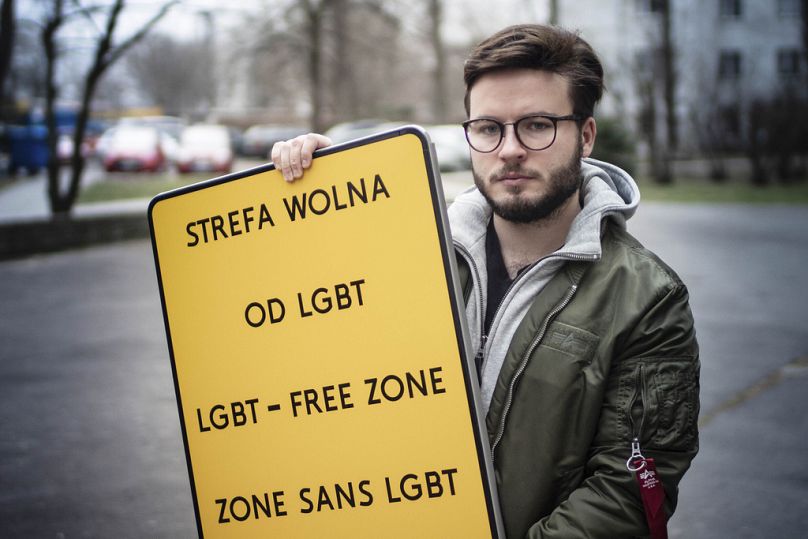Bart Staszewski, an LGBT activist, holds up a sign he uses to protest anti-LGBT resolutions, in Warsaw, January 2020