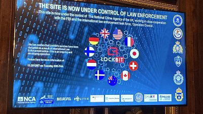 A TV screen shows the front page of LockBit's dark-web leak site that was replaced with the words "this site is now under control of law enforcement,"  Tuesday, Feb. 20, 2024.
