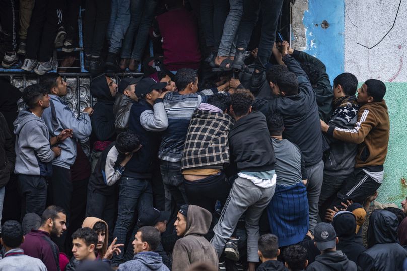 Palestinian crowds struggle to buy bread from a bakery in Gaza on Feb. 18 as supplies dwindle.