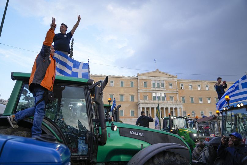 In front of the Greek parliament, protesting farmers rally in Athens, Greece, Tuesday, Feb. 20, 2024.