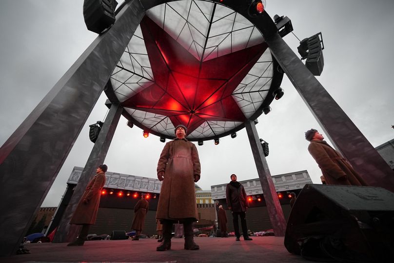 A participant dressed in Red Army World War II uniform takes part in a theatrical performance at Red Square, in Moscow, November 2023