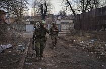 Ukrainian soldiers walk along a street in the area of the heaviest battles with the Russian invaders in Bakhmut, Donetsk region, Ukraine, Wednesday, 15 March, 2023. 