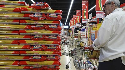 Customers look at packages of pasta on sale in a supermarket in Milan, northern Italy, Thursday, June 8, 2023.