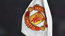 A corner flag showing the logo of Manchester United is seen ahead of the English FA Cup 4th round soccer match between Manchester United and Reading at Old Trafford.